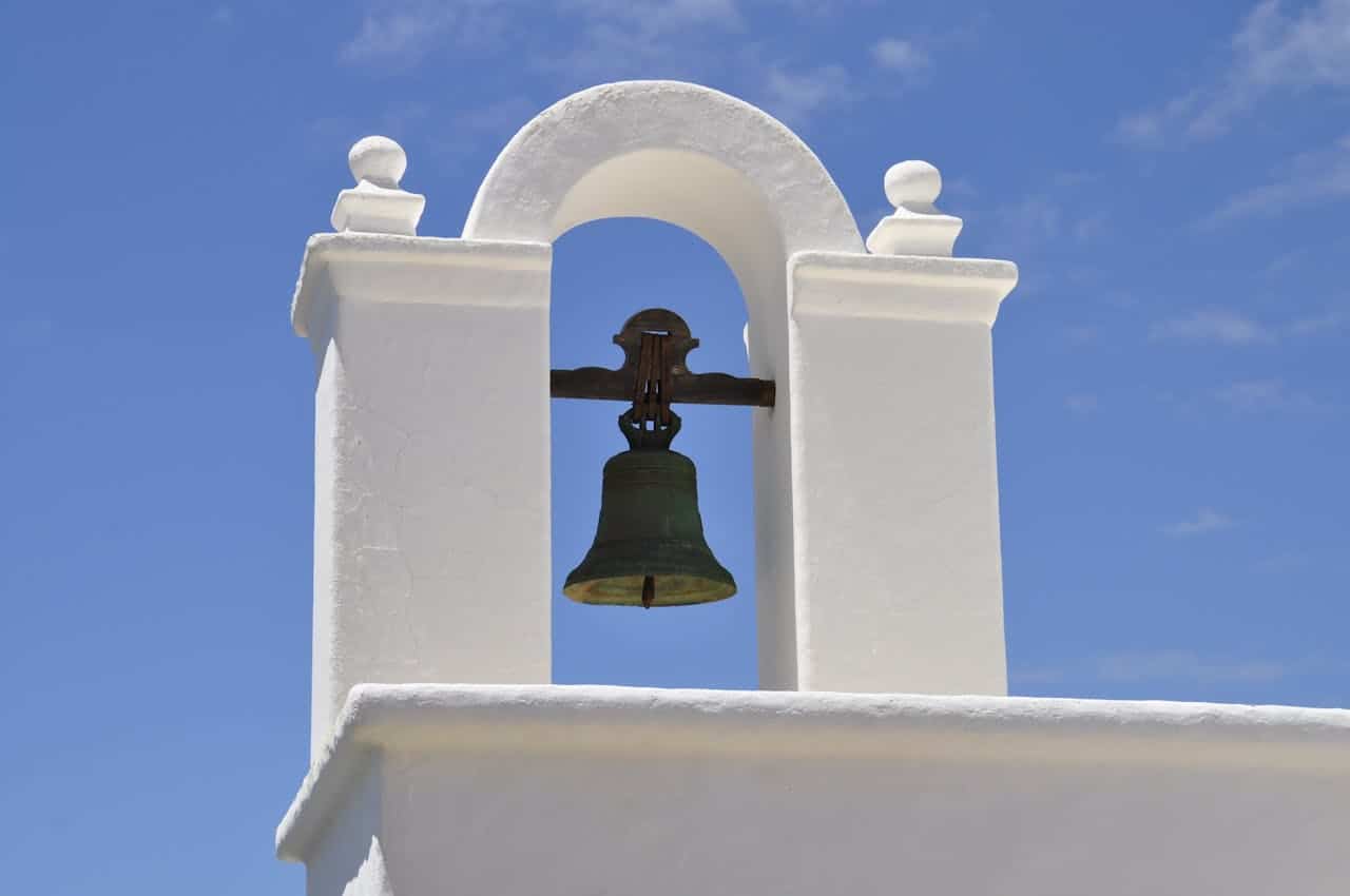 Ageism: Church Bell against blue sky